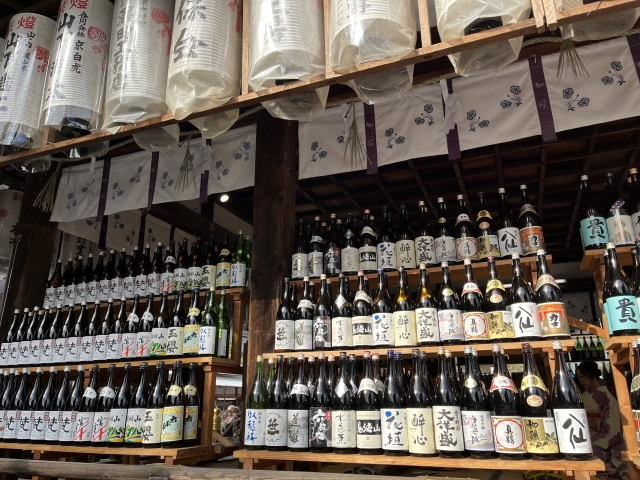 Rows of Japanese sake bottles with kanji labels