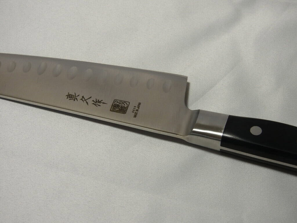 MAC Professional gyuto knife blade with dimpled edge, black handle