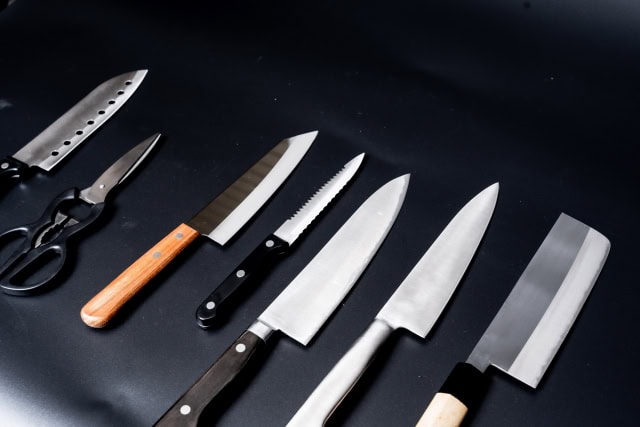 Assortment of best Japanese kitchen knives arranged on a wooden cutting board