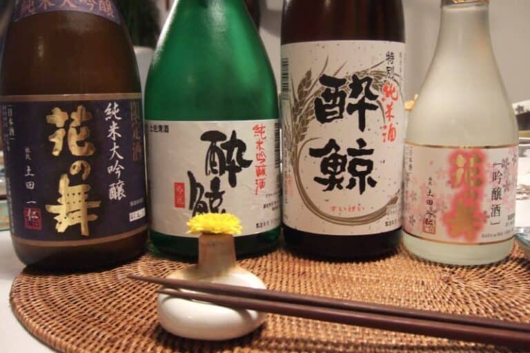 Sake bottles arranged for a tasting with chopsticks