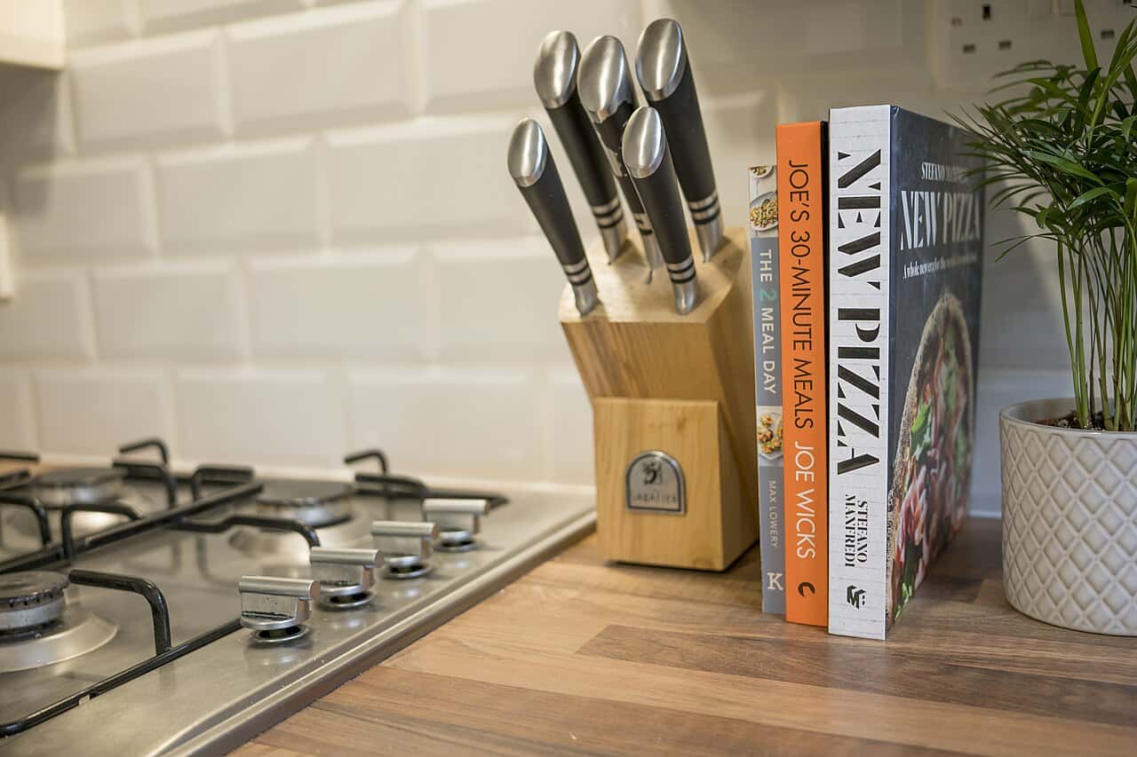 Knives stored in a slotted wooden block on a kitchen counter