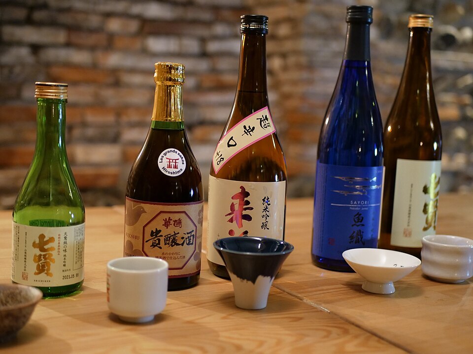 Japanese sake bottles with several styles of serving cup