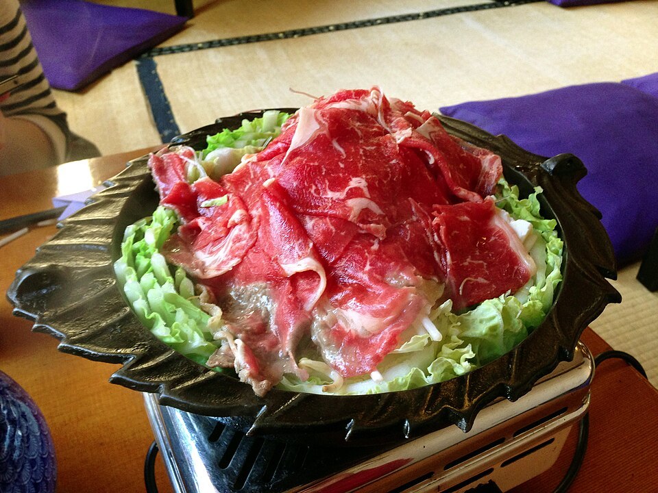 Sukiyaki pot with beef and vegetables ready to cook