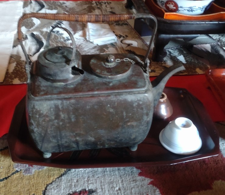 Historical sake-warming equipment displayed at Kobayashi House