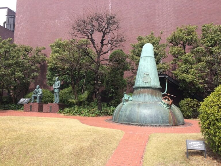 Copper pot still displayed in the garden at Yamazaki Distillery